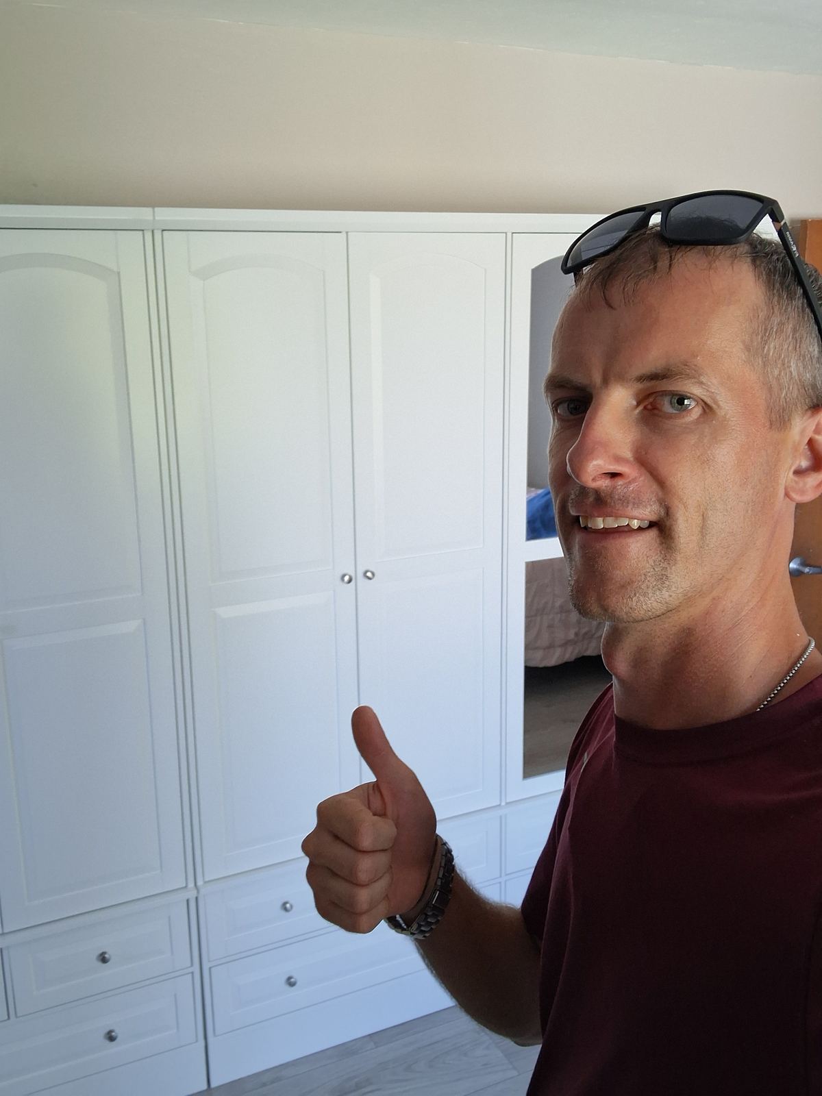 Client giving a thumbs up after wardrobe installation