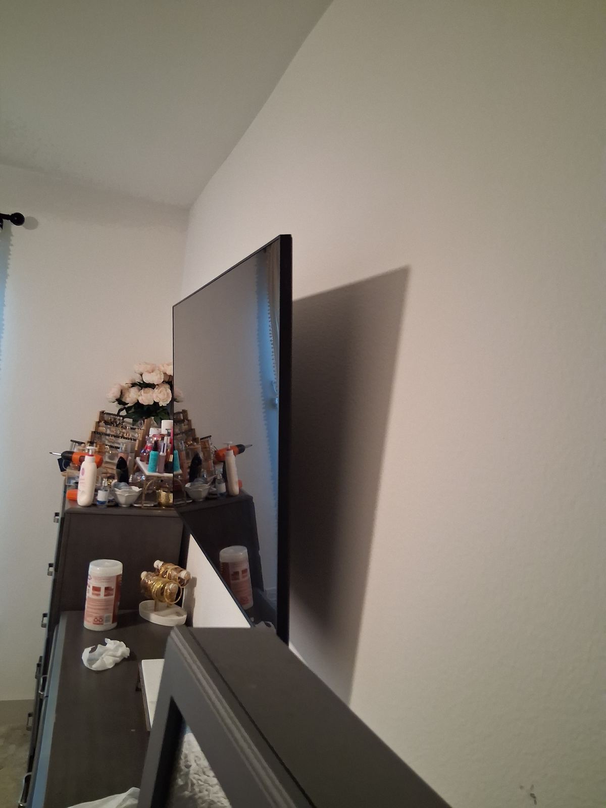 Flat screen TV mounted on bedroom wall